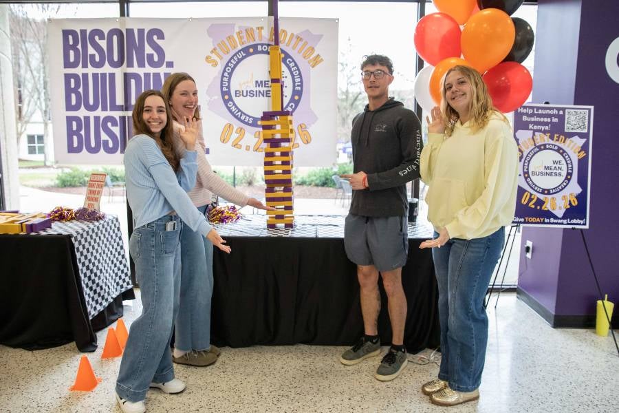 Business students playing Jenga. 