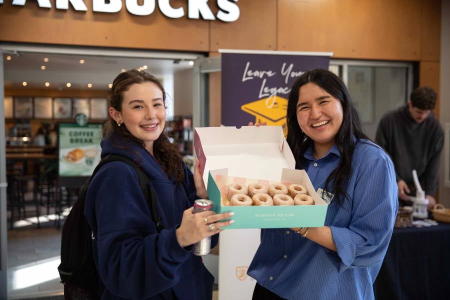 Students holding donuts