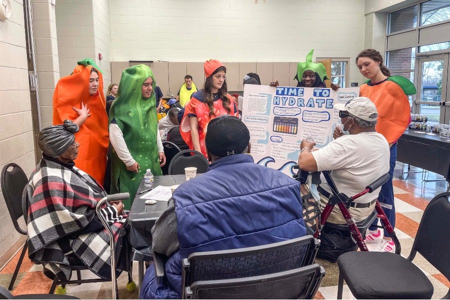 Student nurses teaching Hadley Park seniors about proper hydration