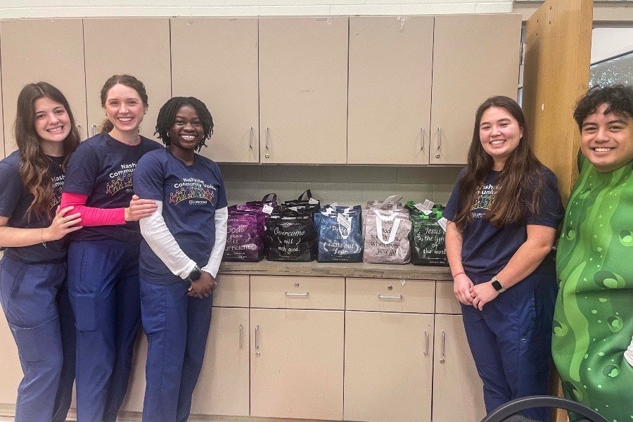 Student nurses with packages of donated supplies