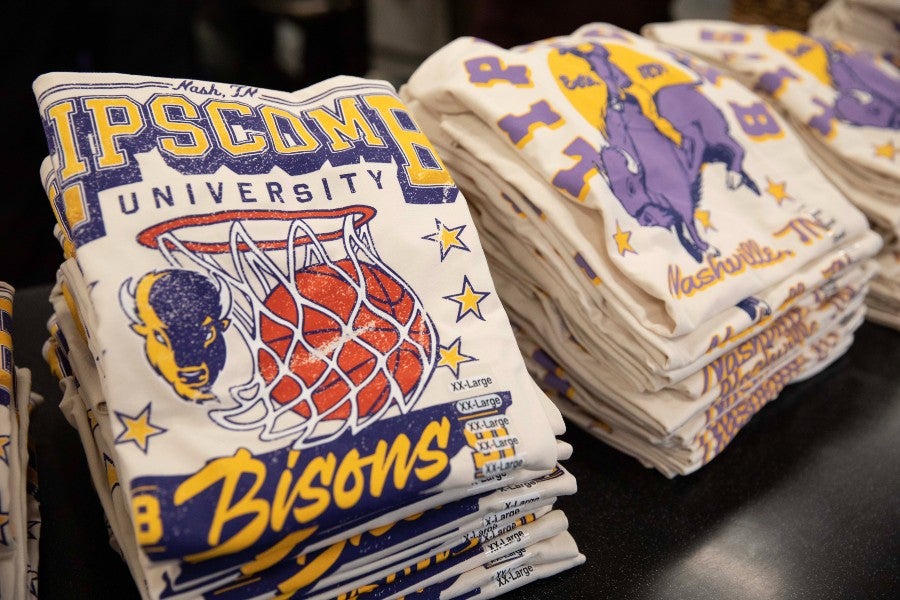 Stacks of T-shirts with Trey Merrill's original design for sale