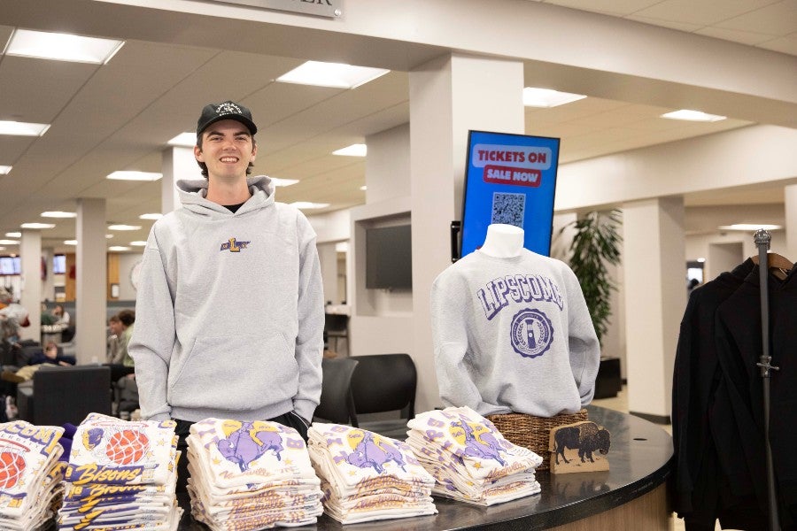 Trey Merrill posing with his clothing collection