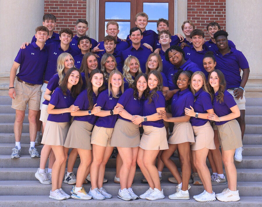 The Quest Team stands in front of Collins Alumni Auditorium