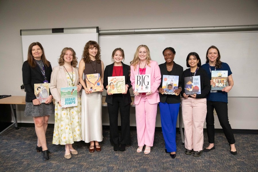 The members of the research group holding the books they recommended