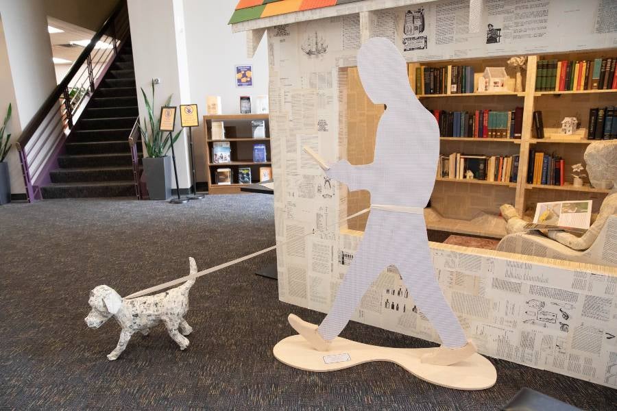 Paper person walking dog