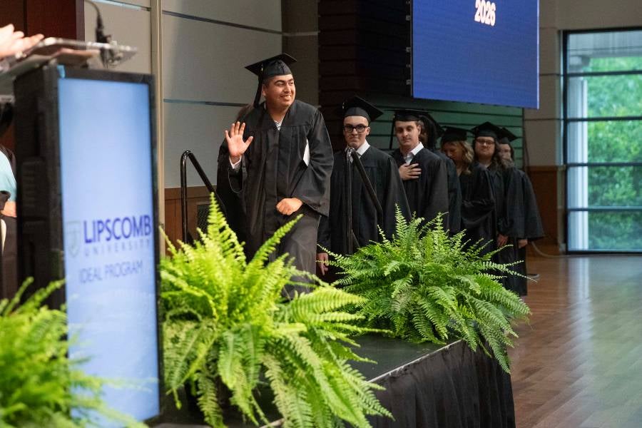 Graduate walking up on stage. 
