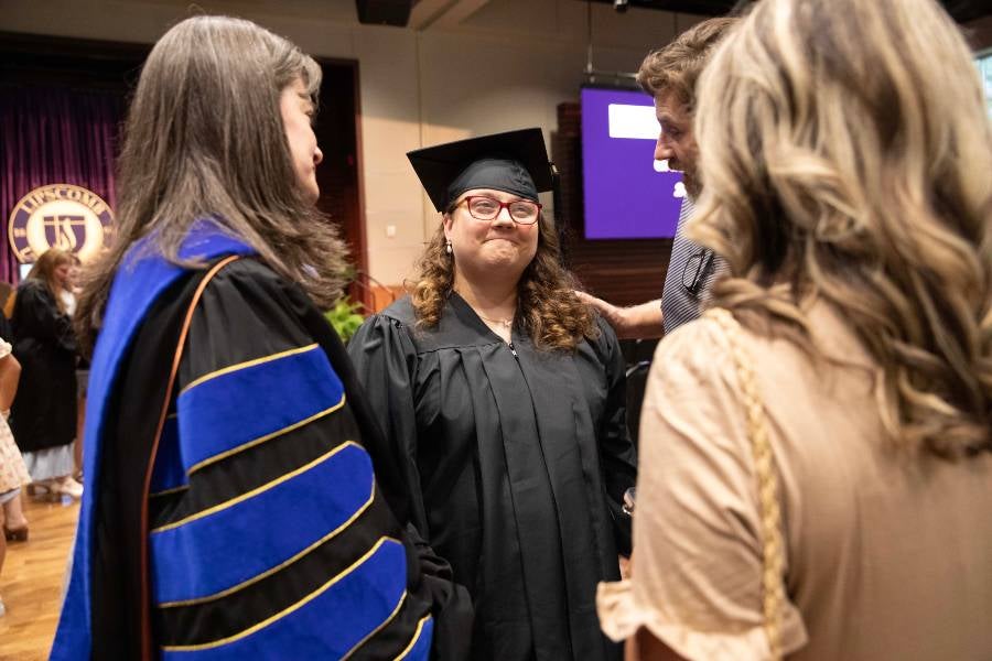President McQueen talking to graduate