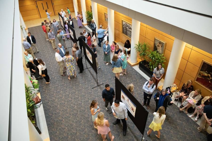 Overhead view of IDEAL students presenting their posters. 