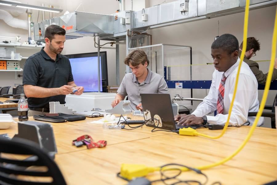 Two students in hydraulics engineering lab