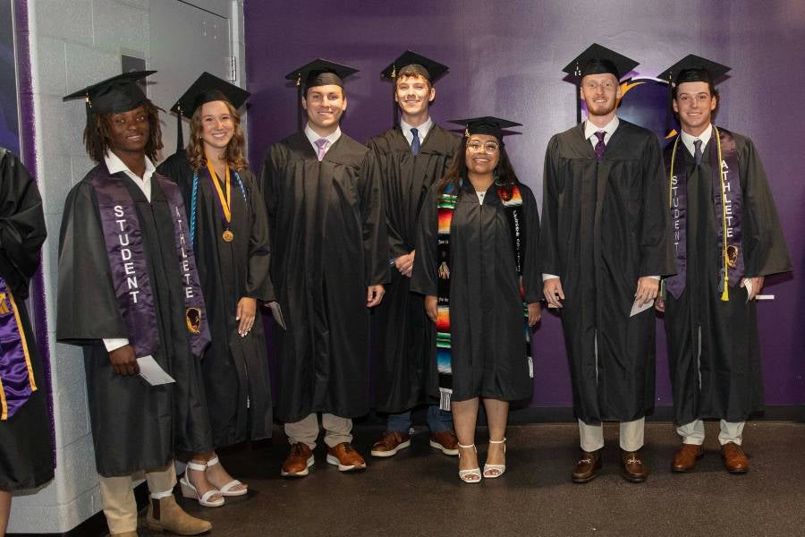 Undergrad students preparing for commencement. 