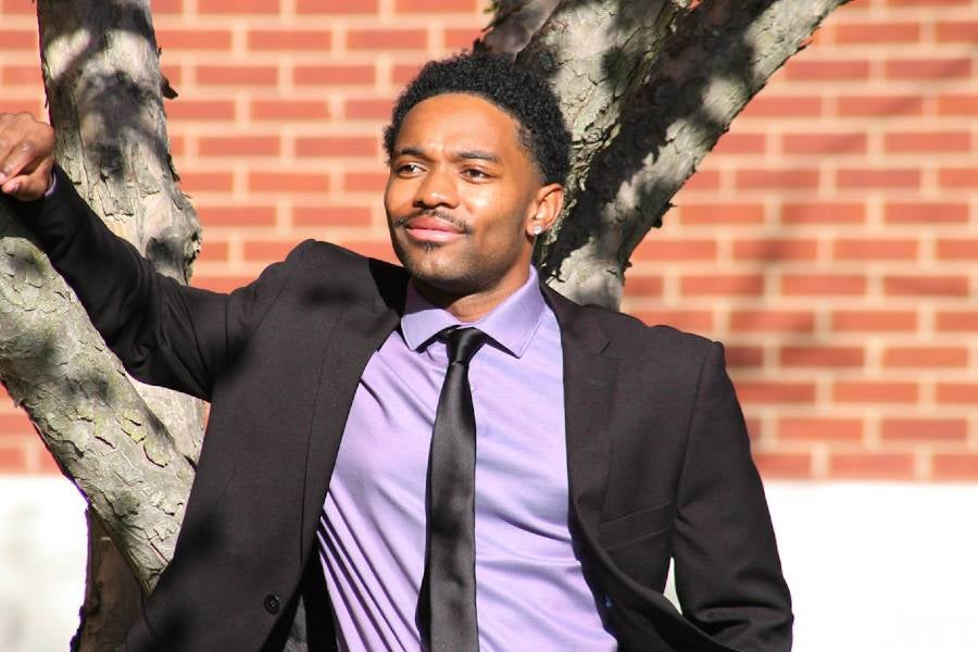 Nate Wallace leaning against a tree. 