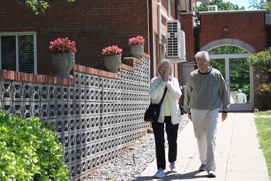 alumni and friends walking through the shaker village