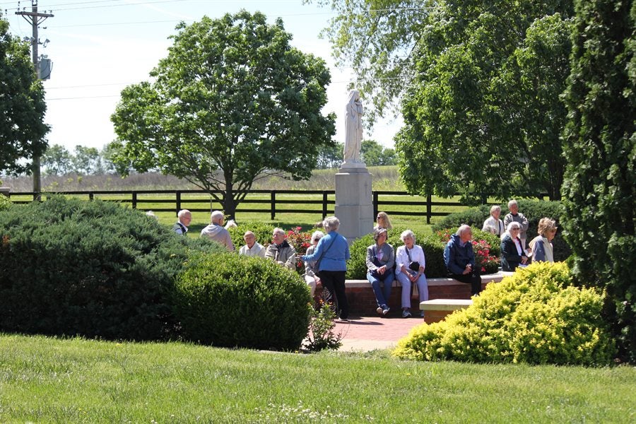 alumni and friends walking near a historic site