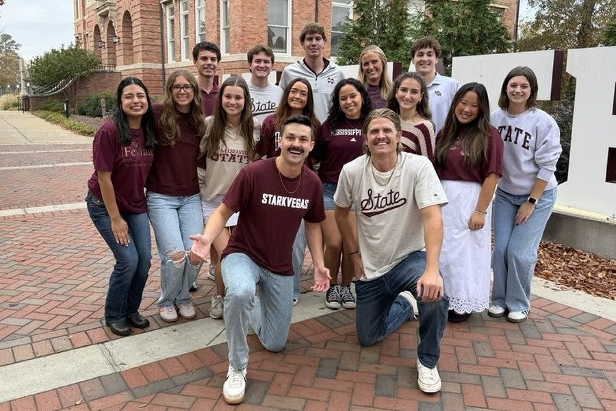 Austin & Colin posing with people at Mississippi State University