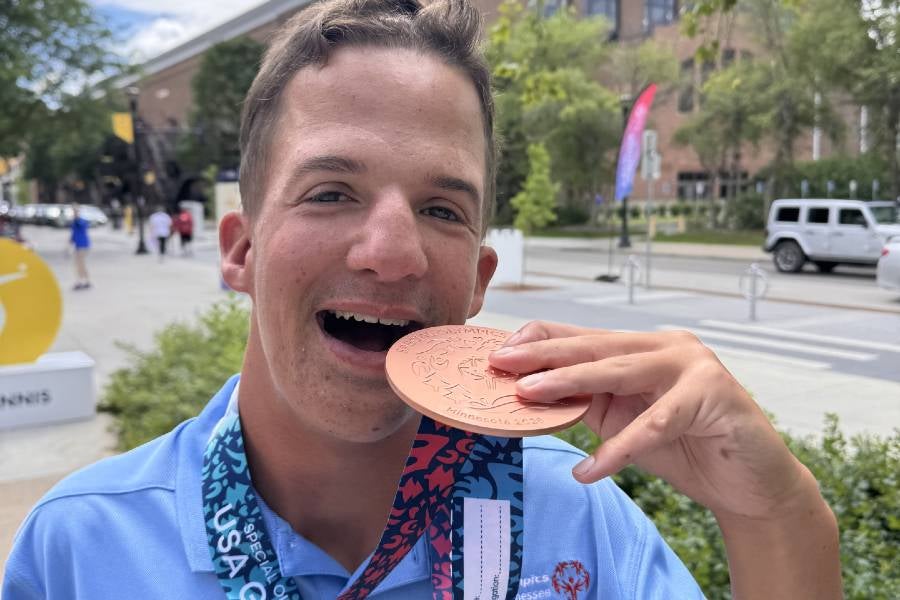 Carter Cottrell with his bronze medal from the Special Olympics USA golf competition. 