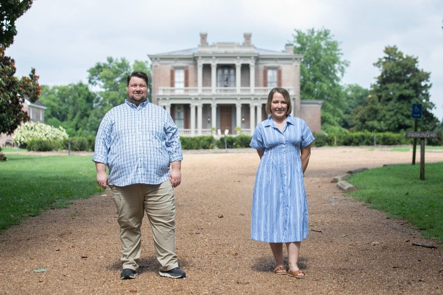 Tracy Harris (left) and Emily Nix (right) standing in front of the Two Rovers Mansion
