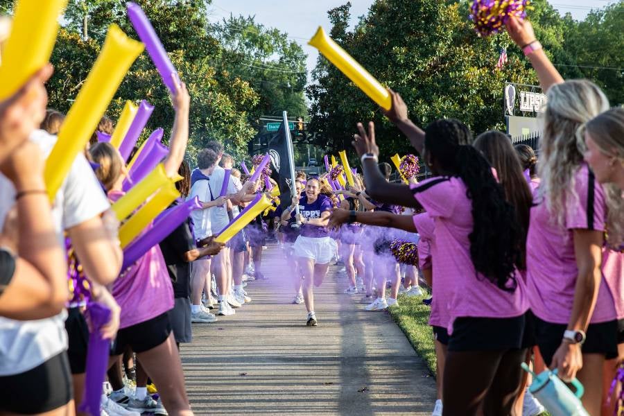 Girl running with flag for Running of the Bison