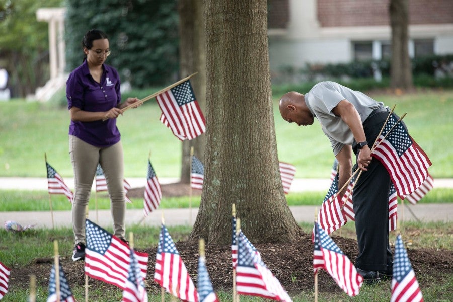 Jimmie Handley setting out flags for a Veterans Day celebration