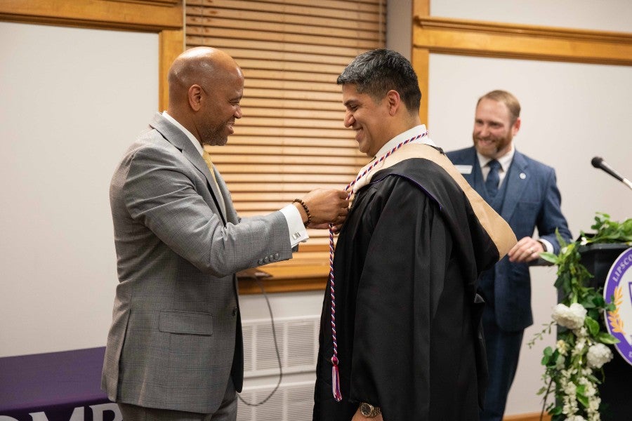 Jimmie Handley with a recent graduate at a veteran-student graduation dinner