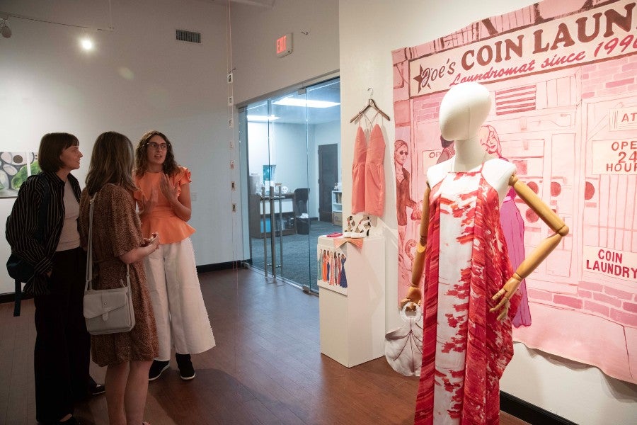 Avry Earnshaw's red caftan dress on display at the opening of the exhibit.