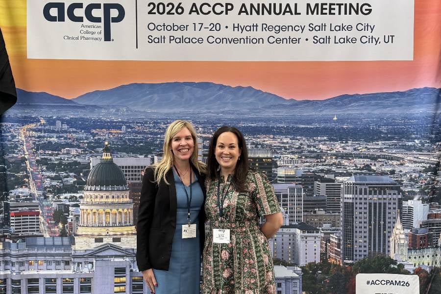 Photo of Lipscomb pharmacy professor Susan Hamblin and Joanna Stallings from Vanderbilt Medical Center standing in front of a backdrop of Salt Lake City. 