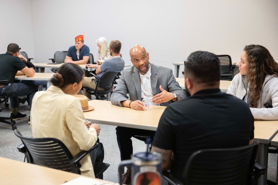 Veteran Services staff speaking with others at a conference 