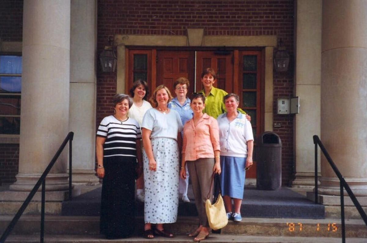 Group of friends posing for a photo on a set of stairs