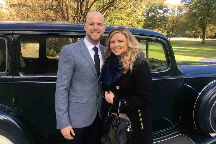 Ryan and wife standing by car