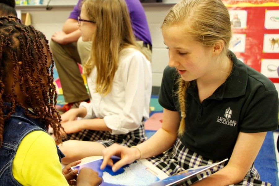 Children reading books in a classroom.