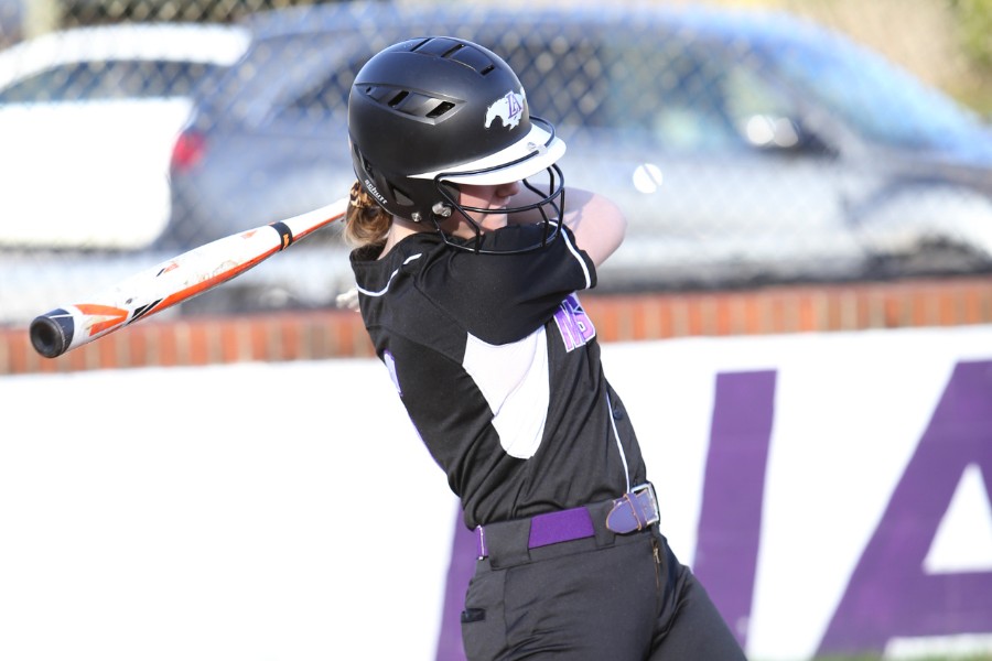 Girl swinging a softball bat.