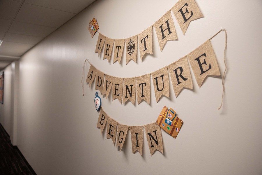 Decor on dorm hallway wall, "Let the Adventure Begin"