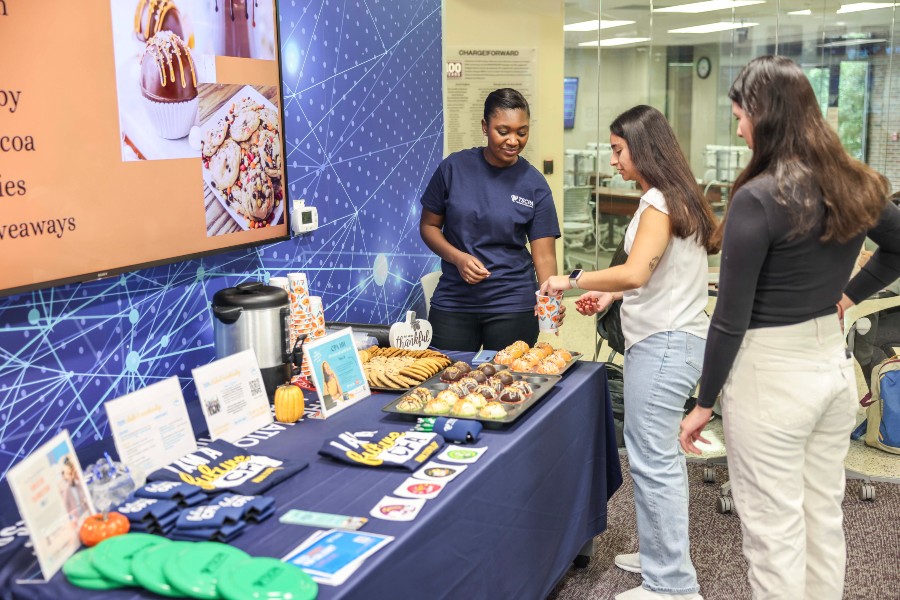 Kara Williams greeting fellows students at her information table