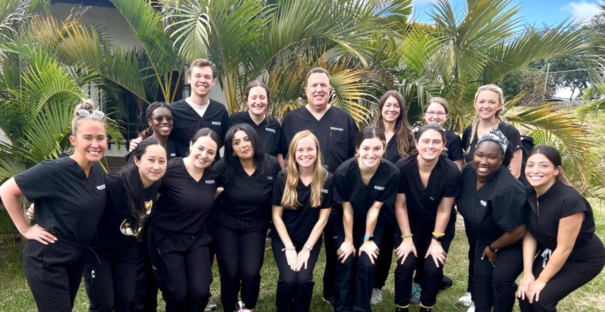 College of Pharmacy mission team poses in scrubs