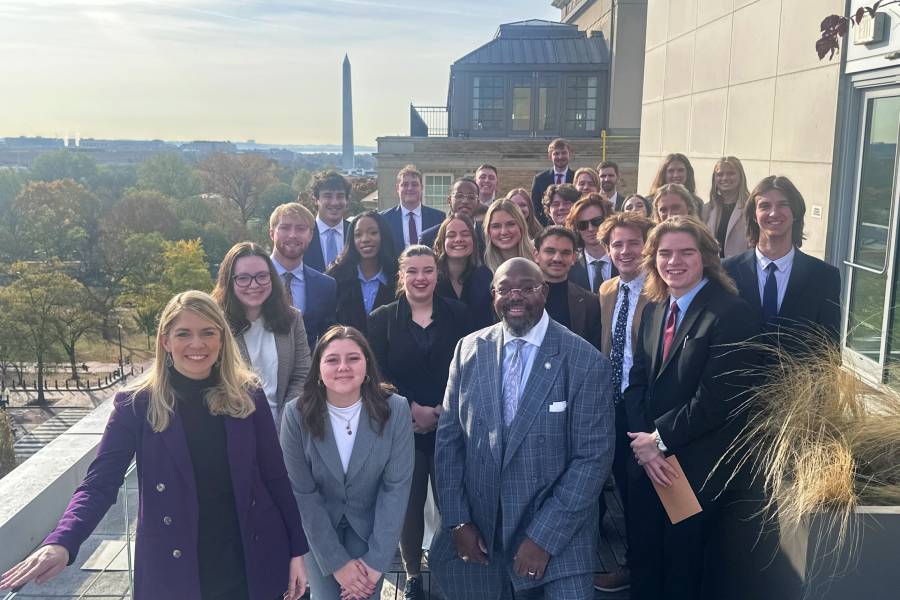 Students gathered in DC with the Washington Monument in the background. 