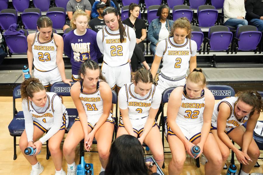 Women's basketball  huddles during a time out. 