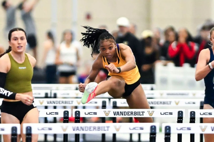 Student athletes jumping hurdles at the championship