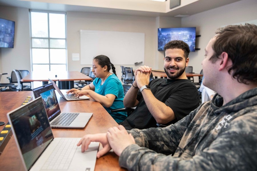 Student Ramy Ismail with his student team working on the Dilemma game