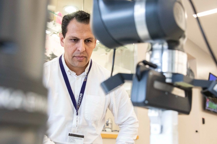 Rojas watching the robot arm at work
