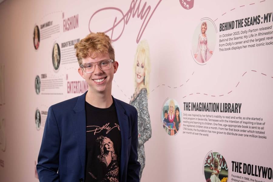 Sean Worth in front of Dolly Parton Exhibition timeline