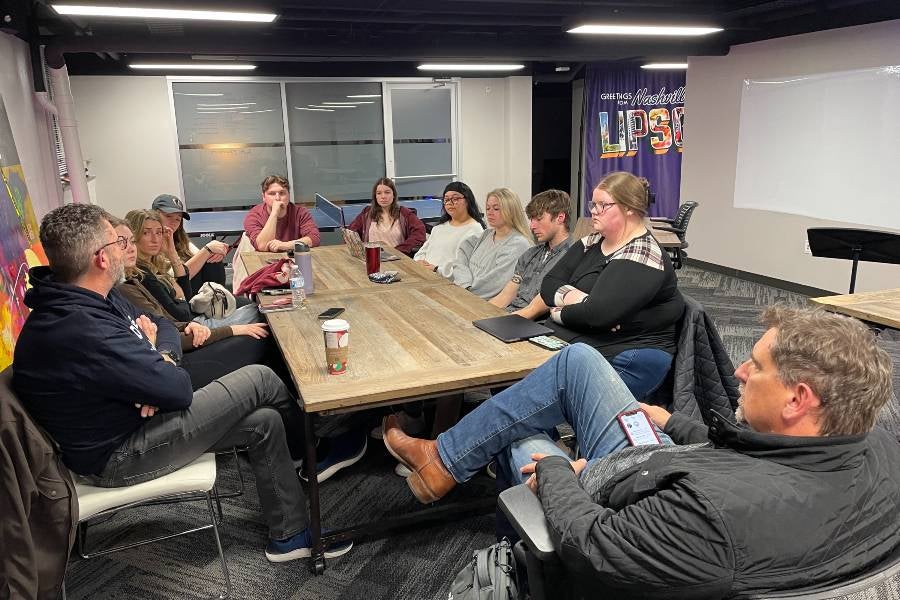 Students have a Red Dog Production meeting.