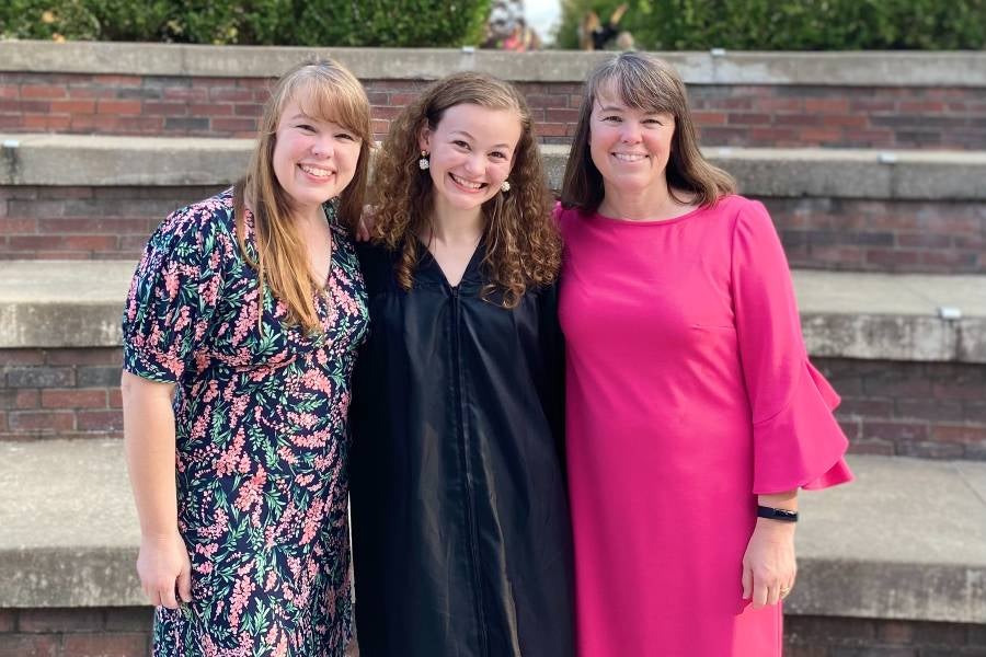 Trevathan, left, and twin sister, Jenny (Oliver) Estes on campus in 2023 to celebrate daughter Katie's graduation from Lipscomb. 