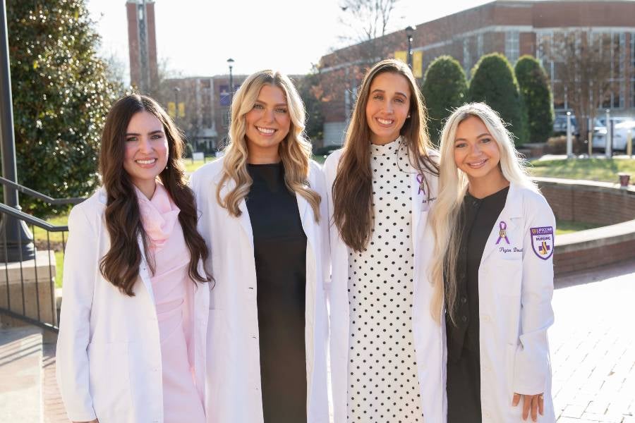 Four nursing students who are the first to graduate through Lipscomb's ABSN degree. 