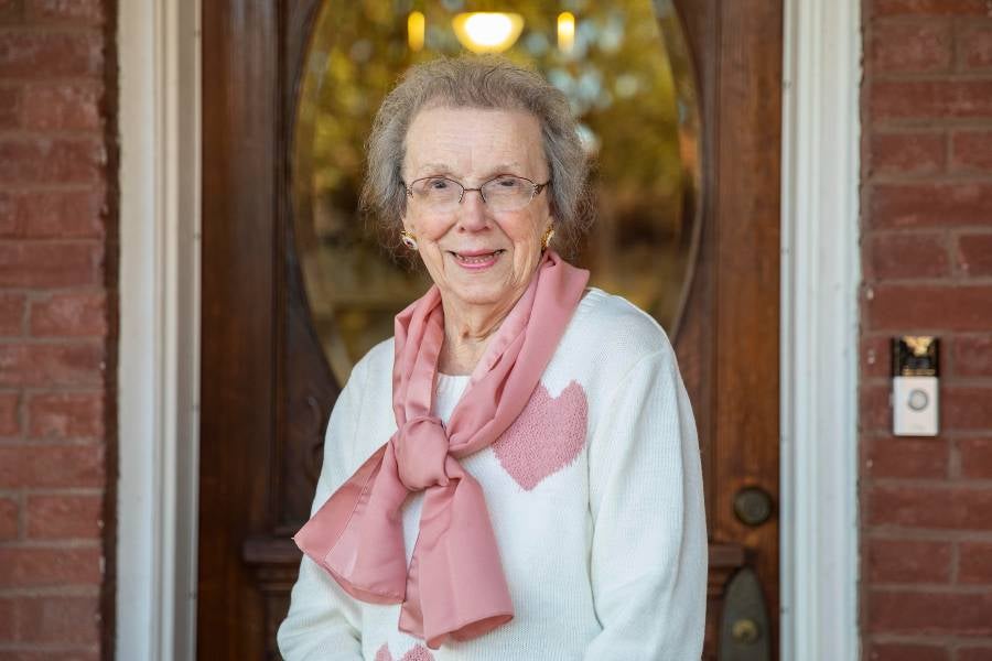 Mary Nelle Hutcheson Chumley stands outside Avalon Home. 