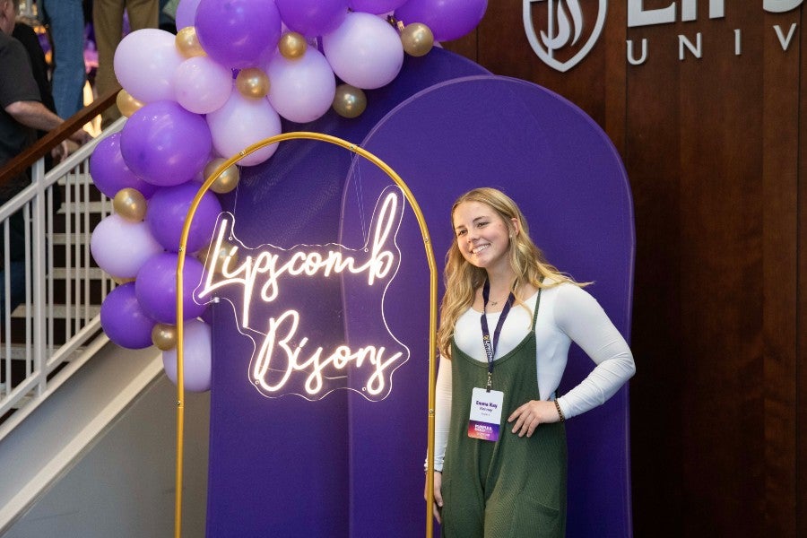 A student at the photo corner at a 2025 Purple and Gold Day