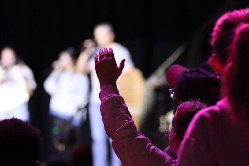 Students worshipping during Impact  