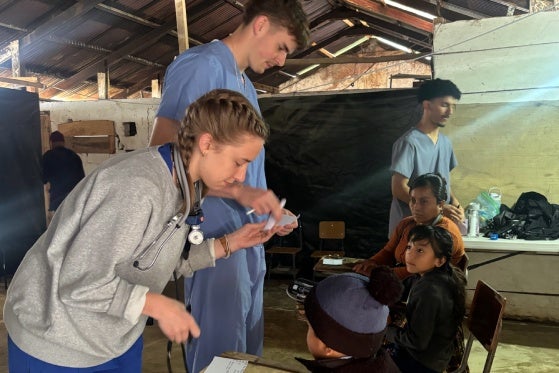 Students working with local children in a clinic. 