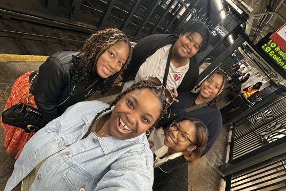 Team on the Train platform taking a selfie. 