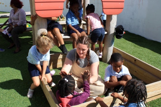 Student and community playing in a playground.