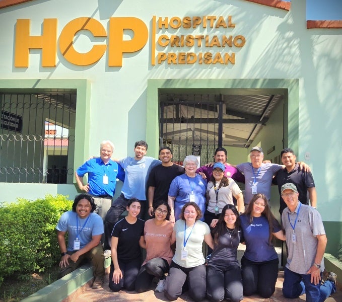 Team standing before the Predisan Hospital 