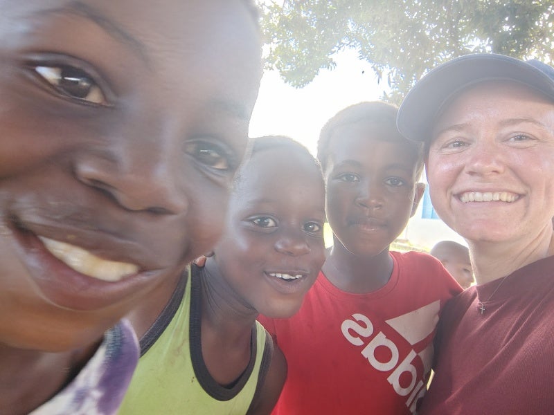 Leader and Kids smiling for the camera